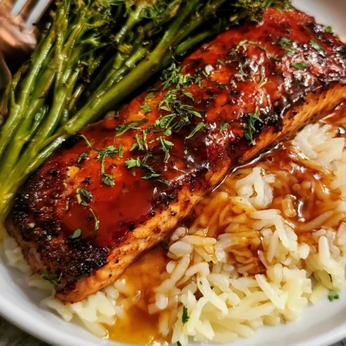 Delicious honey glazed salmon served with rice and broccoli on a plate