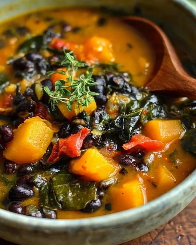 Black bean stew with butternut squash and collard greens served in a bowl