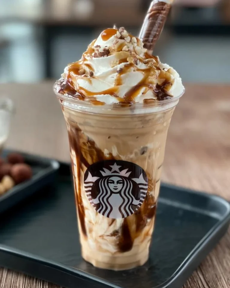 Delicious cold coffee drink served in a glass with ice and whipped cream