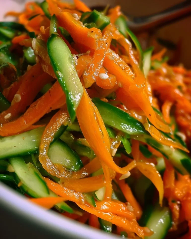 Fresh Cucumber and Carrot Salad served in a bowl with dressing