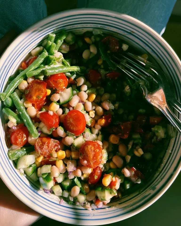 Dense bean salad filled with fresh vegetables and protein-rich beans.