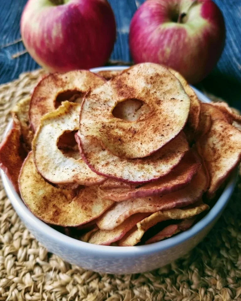Bowl of irresistible cinnamon apple chips, a healthy and delicious snack.