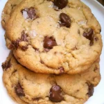 Freshly baked chocolate chip cookies on a cooling rack