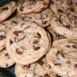 Freshly baked chewy chocolate chip cookies on a cooling rack