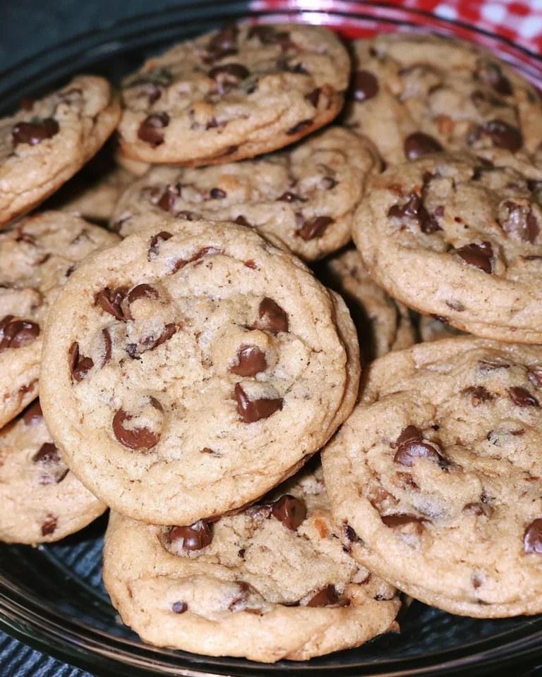Freshly baked chewy chocolate chip cookies on a cooling rack